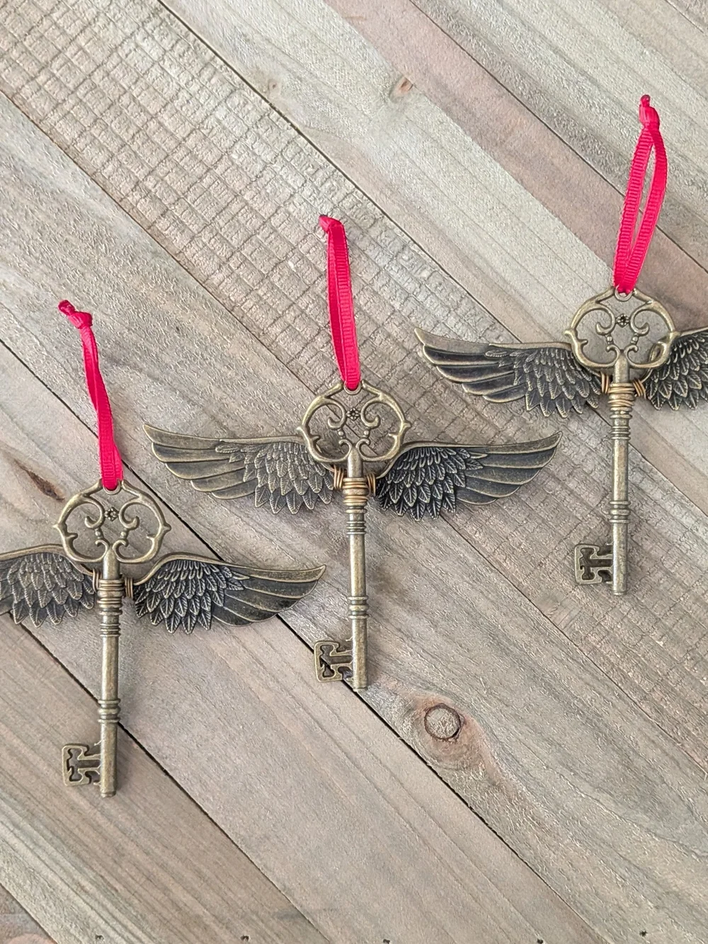 Vintage Brass Winged Key Ornament with Red Ribbon